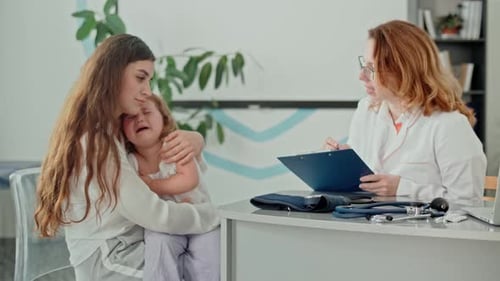 Little Girl Cries at Doctor's Appointment with Mother