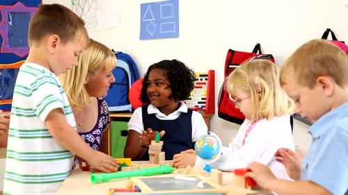 Children and Teacher Play with Blocks in Classroom