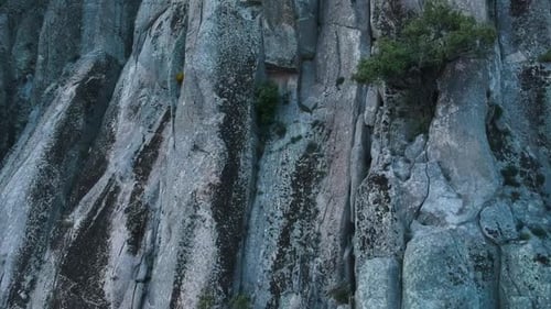 Rock Climbers Ascend Steep Cliff Face