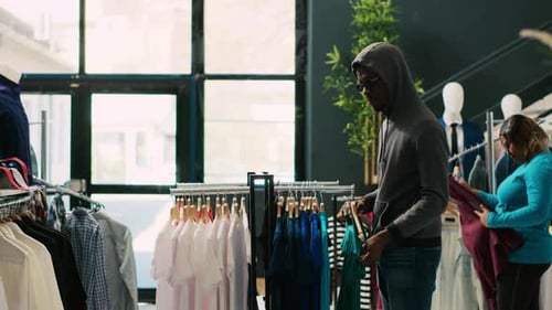 Robber Shoplifting Clothes
