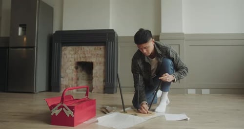 Young Adult Assembling Furniture at Home