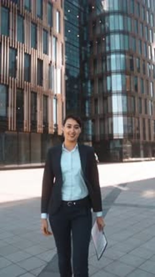 Cheerful Professional Woman Presents Contract for Signature