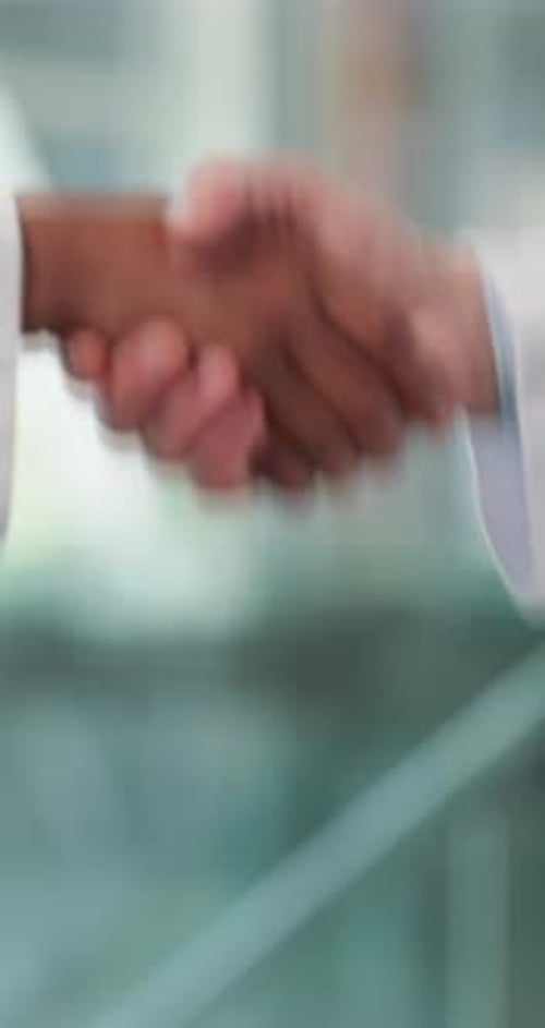 Doctors, shaking hands and agreement in hospital, lobby and thanks with welcome for hiring