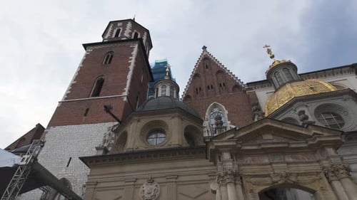 Wawel Cathedral in Krakow captured from below with historic architecture under a cloudy sky