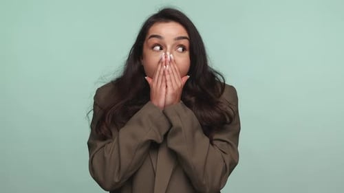 Shocked Woman with Hands Over Mouth Expressing Surprise