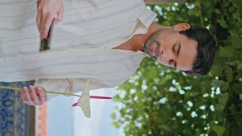 Young Adult Taking Picture of Flower with Phone