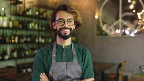 Portrait of Smiling Young Bearded Waiter Male Standing in Restaurant