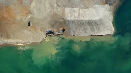 Aerial View of Crane Next to Turquoise Water