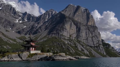 A Tranquil and Serene View of Majestic Mountains Alongside a Traditional Pavilion By the Water