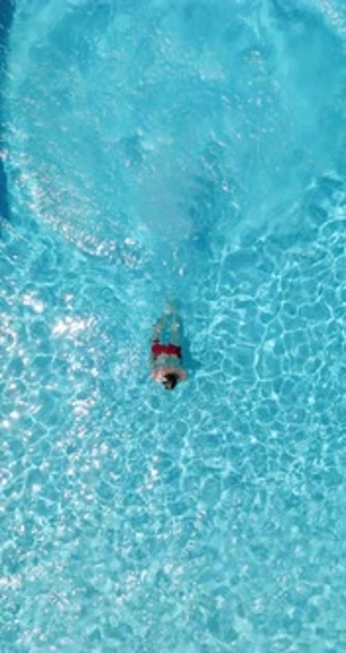 Blue Water in the Swimming Pool with Light Reflections