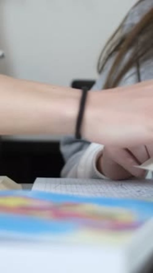 Teen Studying, Reading, and Writing at Desk