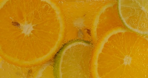 Refreshing Sliced Oranges and Limes in Sparkling Water