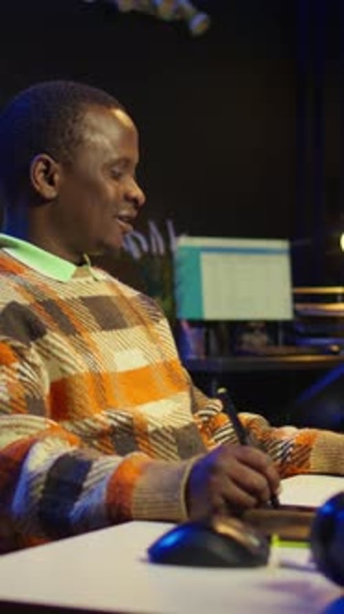 Creative Adult Works at Desk with Stylus