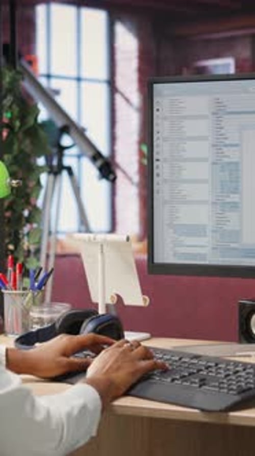 Vertikaler Videoprogrammierer am Computertisch, Codierung und Erstellung von Software