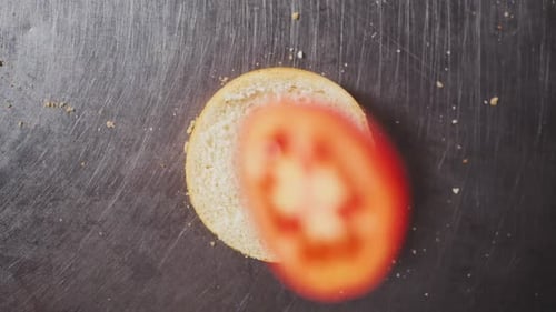 Tomato Slice Added to Burger Bun Overhead