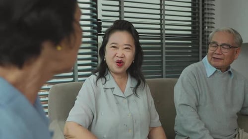 Seniors Talking and Laughing Together on Sofa