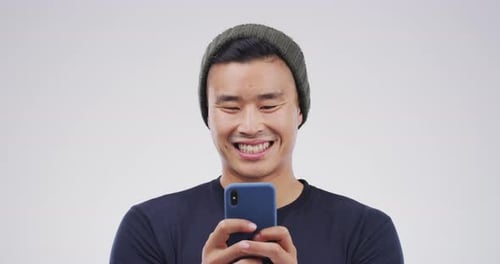 Young Adult Laughing and Smiling at Phone