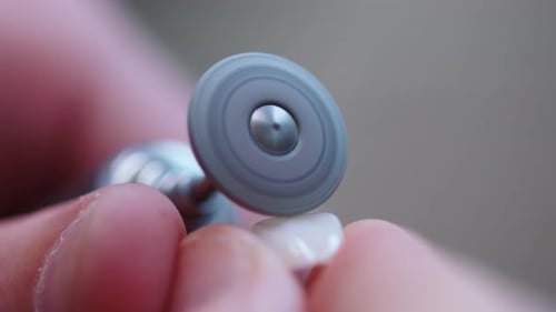 Close Up Man Dentist Hands Setting Dental Tooth Crown on Jaw Model Working on Dentures Use