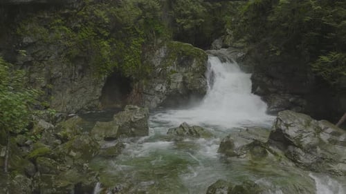 Water rushes over the jagged rocks in Lynn Canyon Vancouver