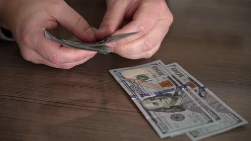 Close up cadres of male hands, successful businessman counts money.