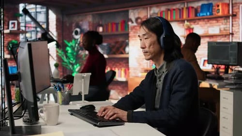 Startup Office Chief Technology Officer Listens Music While Coding Application