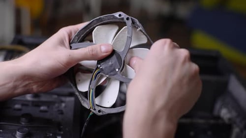 Close Up Hands of Unrecognizable Computer Master Male Cleaning Dusty Big Fan on Radiator That