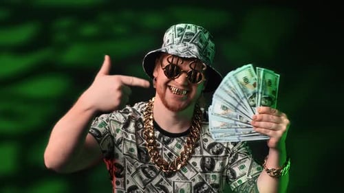 Man Shows Off Gold Jewelry and Hundred Dollar Bills