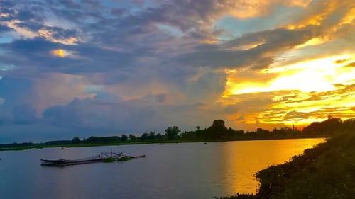 The beautiful sunset over the calm waters of the lake makes for a perfect view