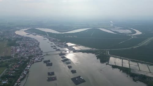 An aerial view of a river running through a fishing village