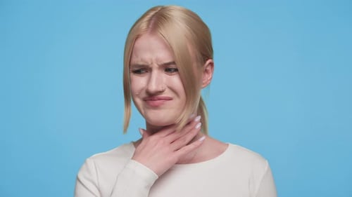 Woman Holding Sore Throat in Studio Close Up