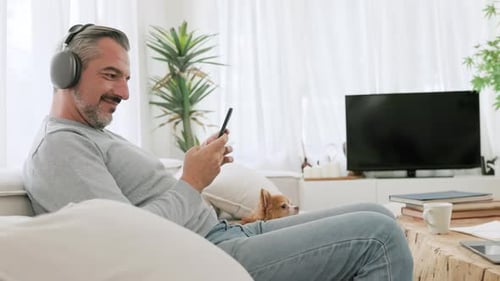 Middle-aged man in headphones listening to the music