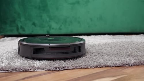 Close up of modern cleaning device helping to clean the carpet in the apartment