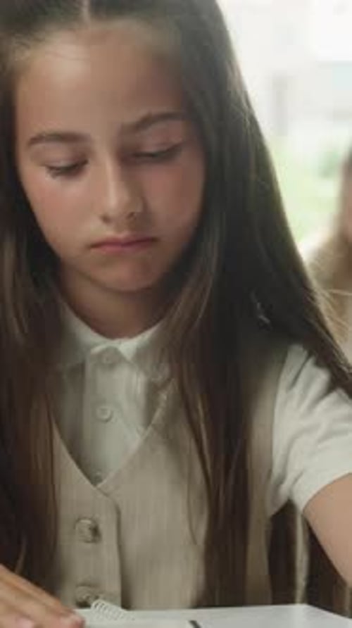 Sad Caucasian Little Girl Child Reading Book in Classroom Bored Pupil Tired Read Literature