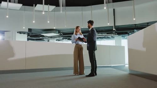 Couple of Formal Office Managers Discussing Financial Plans Standing in Modern Office Lecturing Room
