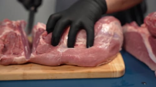 Preparing Raw Meat on Wooden Cutting Board