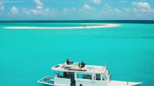 Family Travels on a White Boat Near the Sandbar to the Vaavu Atoll Maldives Aerial View on Turquoise