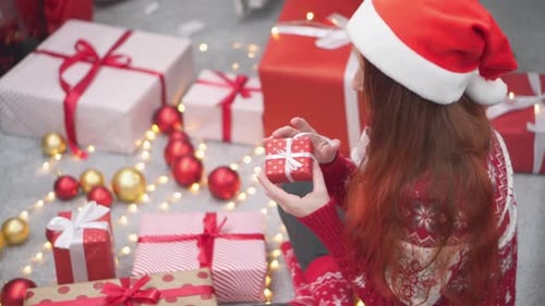 Woman Unwraps Christmas Gift