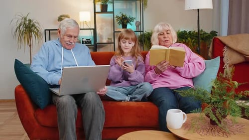 Grandparents Relaxing with Granddaughter in the Living Room