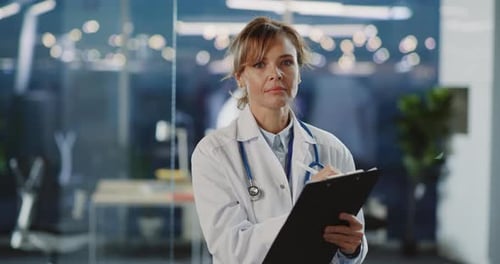 Portrait Face of Attractive Female Caucasian Doctor Professional Wearing Medical Gown Writing Down