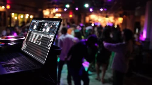 Crowd Dancing to Music at Nightclub Event