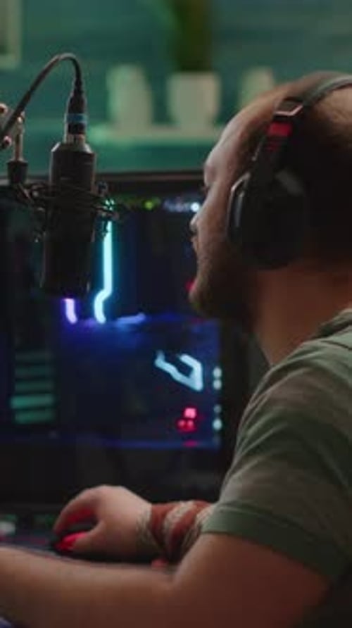 Man Gaming with Computer, Headphones, and Microphone