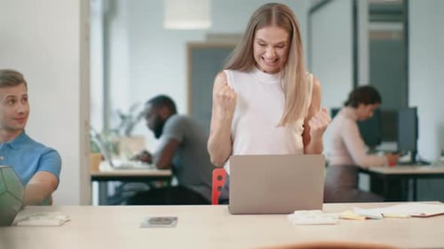 Excited Business Woman Enjoy Good News on Laptop in Office. Happy Freelance