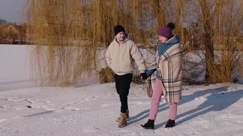Couple Walking Hand-in-Hand in a Winter Scene