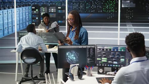Woman in Server Hub Using AI Visualization Insights on Tablet Device