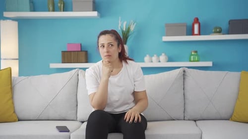 Woman Thinking on Couch in Colorful Room