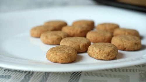 Delicious Cookies Being Arranged on a White Plate