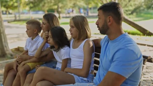 Family Enjoying Quality Time Together on Park Bench