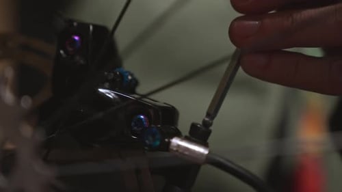 Close-up of a bicycle brake mechanism, showing intricate details of the gears and cables