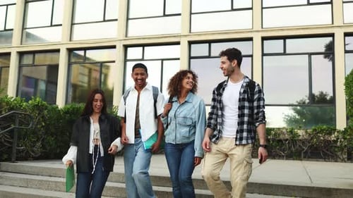 Diverse students walking and talking outside a modern campus building