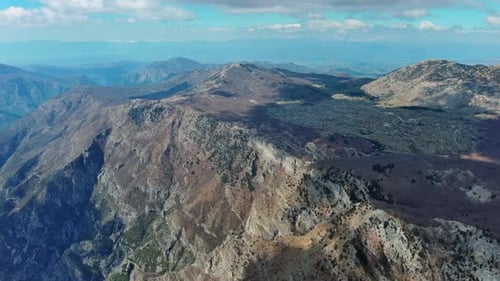 Aerial View of Rocky Mountain Peak and Green Valley